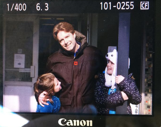 Picture of the digital screen on the back of a camera, showing an image of Larry and his girls on election day.